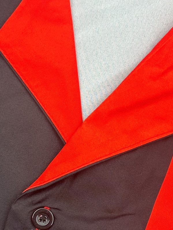 new products in 2025, a two piece set consisting of a simple cuban collar long sleeved men's shirt and long pants. the set features an artistic black and red color blocking style, suitable for casual wear, vacations, and daily outings.