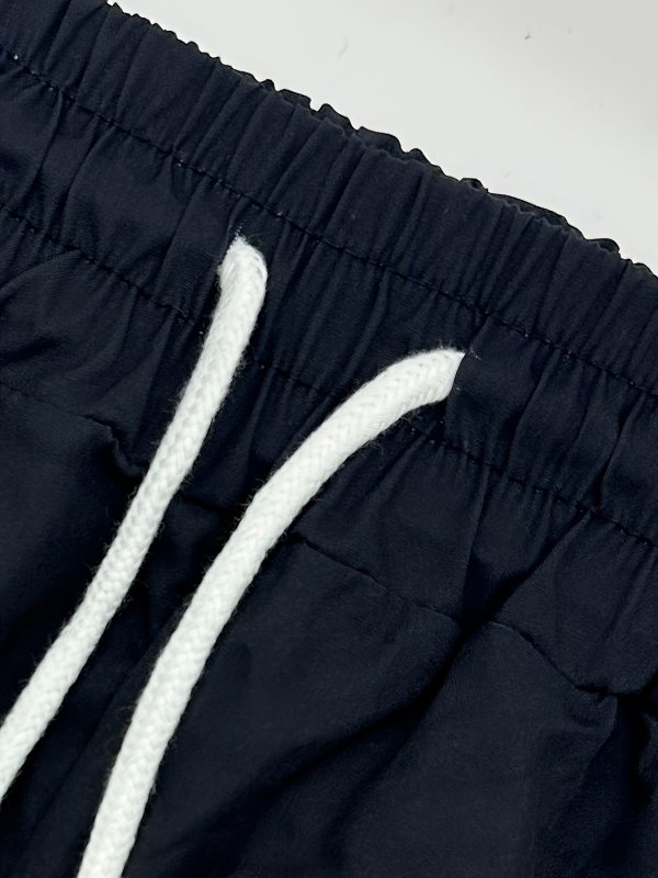 new products in 2025, a two piece set consisting of a simple cuban collar long sleeved men's shirt and long pants. the set features an artistic black and red color blocking style, suitable for casual wear, vacations, and daily outings.